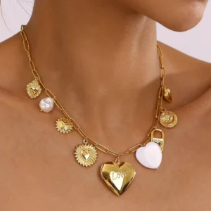 18K gold heart locket charm necklace worn on neck, close-up view of polished gold finish and mixed pendant charms on female model