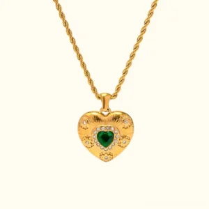 18K gold heart necklace with emerald centerpiece and crystal pavé pendant, front flat lay view on plain background