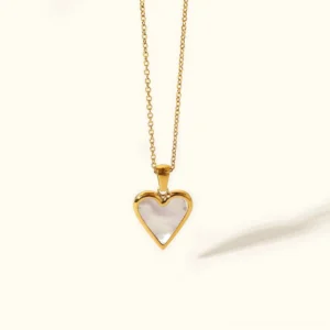18k gold heart necklace with mother of pearl pendant on delicate gold chain flat lay product photography