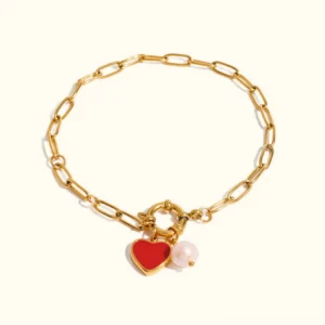 18K gold heart pearl bracelet with red enamel charm and freshwater pearl - flat lay studio view