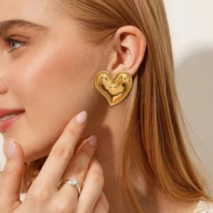 18K gold heart earrings worn on ear close-up side profile view model demonstration