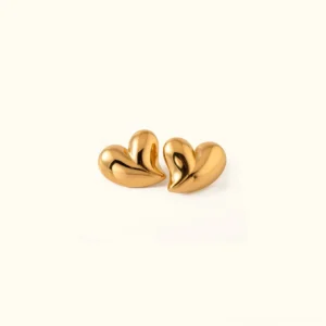 18K gold heart stud earrings polished puffy design flat lay view premium jewelry