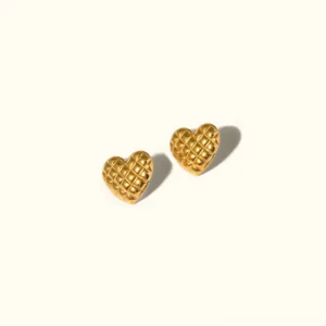 18K gold heart stud earrings with quilted diamond lattice texture, flat lay product photography on neutral background
