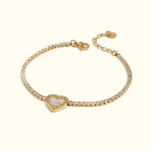 18K gold diamond heart tennis bracelet with pavé crystal band and mother-of-pearl heart charm, flat lay front view on plain background