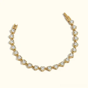18K gold heart-shaped tennis bracelet overhead flat lay view showing heart-cut gemstone settings in luxurious gold coating