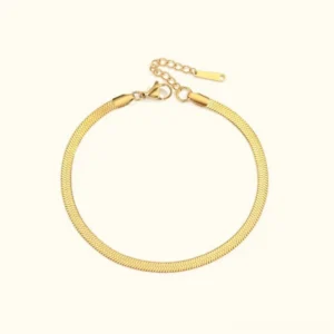 18K gold herringbone anklet flat lay display with adjustable clasp chain on light background product shot