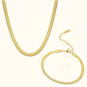 18K gold herringbone necklace and bracelet set flat lay on white surface showcasing both pieces together