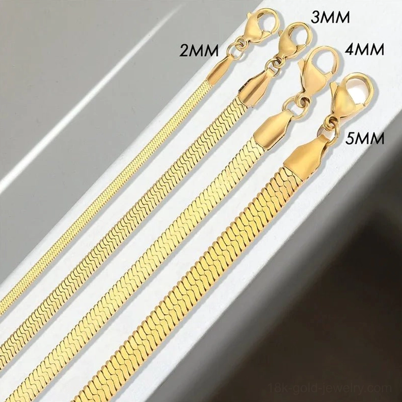 Complete 18K gold herringbone necklace collection all four widths 2mm 3mm 4mm 5mm displayed flat lay