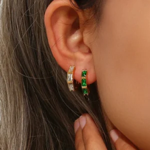 18K gold diamond and emerald hoop earrings worn on ear, comparison view showing both stone color options