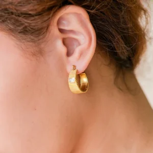 18K gold hoop earrings close-up side view worn on model ear showing rectangular gemstone detail