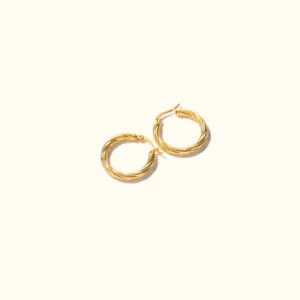 Small 18K gold smooth polished hoop earrings top-down flat lay view on plain background