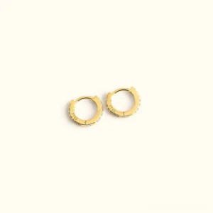 18K gold huggie earrings with crystal pavé detailing flat lay view top angle minimalist design