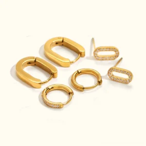 18k gold huggie hoop earring set flat lay top down view all styles round oval pavé diamond studs white background
