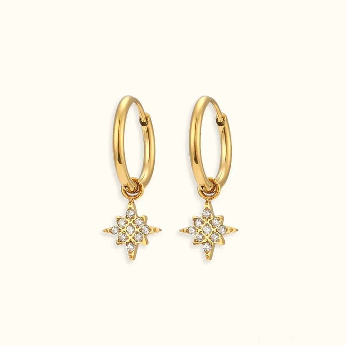 18K gold starburst drop huggie hoop earrings with cubic zirconia charm flat lay front view