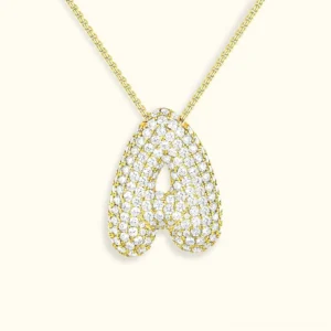 18K gold personalized initial diamond bubble pendant necklace flat lay with sparkle detail