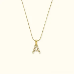 18K gold initial letter A pearl pendant necklace with rhinestone charm, front flat lay view on neutral background