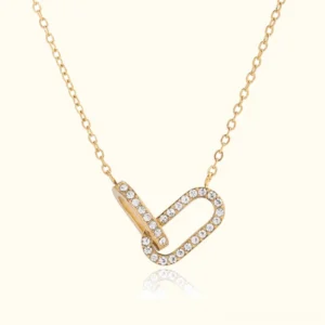 18K gold interlocking diamond pendant necklace flat lay studio view with cubic zirconia paved loops and gold cable chain