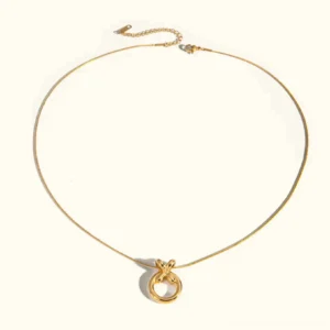 18k gold knot circle pendant necklace flat lay polished metal finish top view