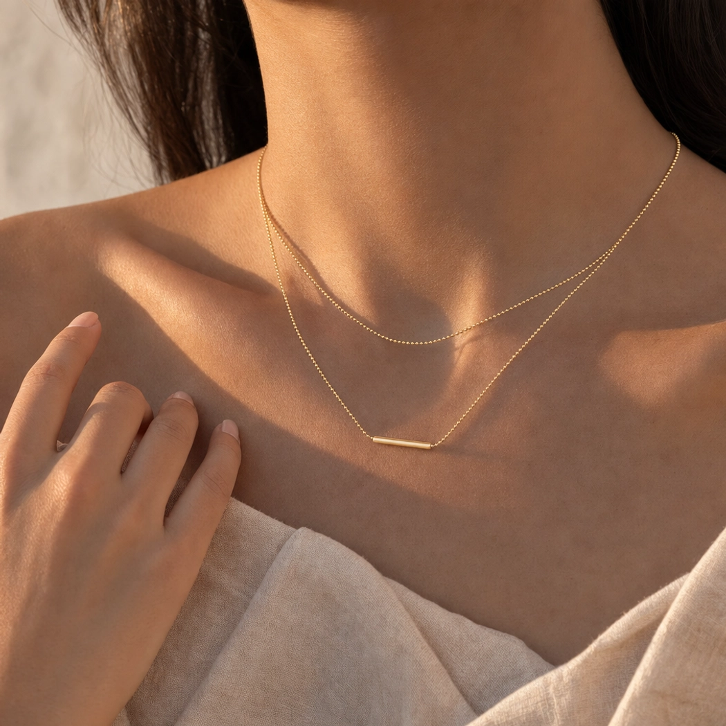 18K Gold Layered Bar Necklace worn with linen outfit on model showing versatile styling and minimalist aesthetic