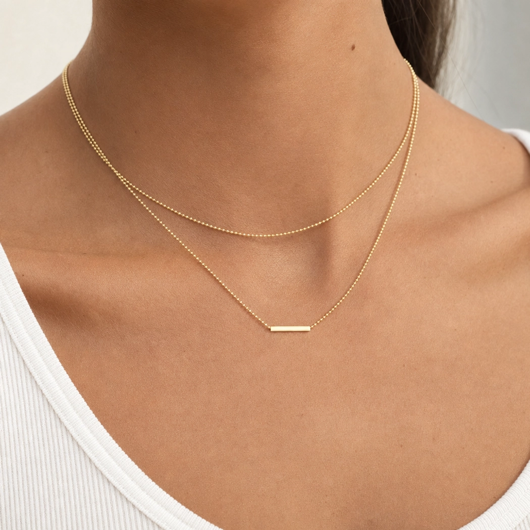 18K Gold Layered Bar Necklace on model wearing white tank top showcasing collarbone positioning and everyday wearability