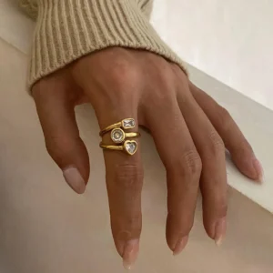 18K gold diamond ring worn on female hand showing layered design with polished finish close-up view