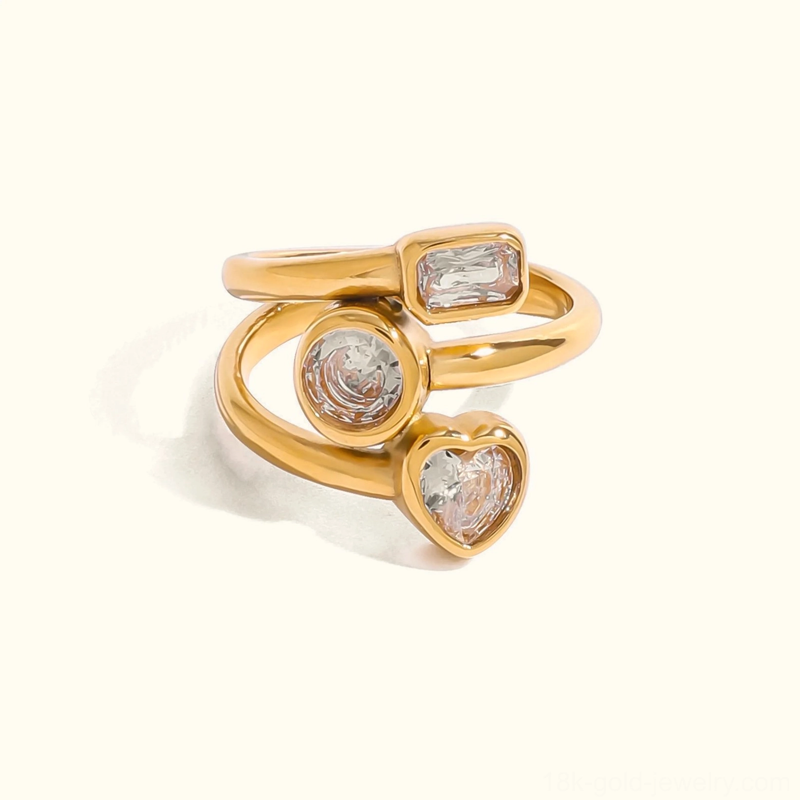 18K gold layered diamond ring with heart round and baguette cut gemstones flat lay top view