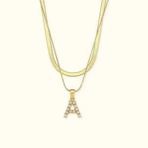 Double-layer 18K gold initial letter necklace with freshwater pearl pendant, front view on white background