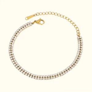18K gold double-layer tennis bracelet with AAAAA diamond simulant pavé crystals, flat lay product photography on plain background