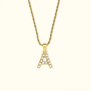 18K gold letter A initial diamond pendant necklace front flat view with thin solid chain and sparkling clear diamond stones on off-white background