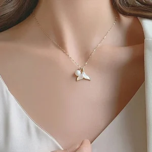 18K Gold Mermaid Pearl Necklace Worn on Model - Collarbone Close-Up Neckline View