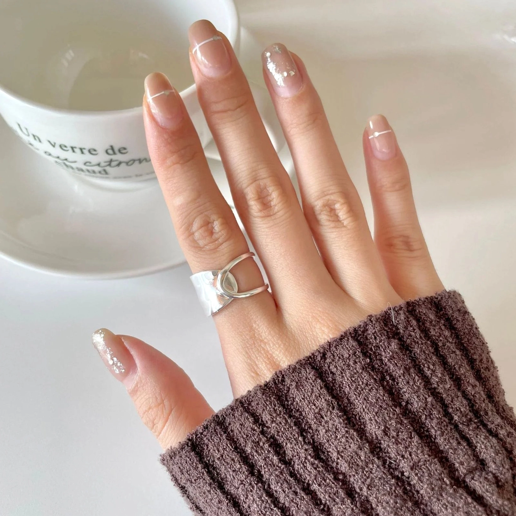Minimalist 18K gold open ring geometric hollow design worn on hand with coffee scene
