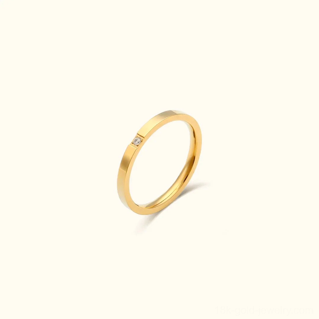 Minimalist 18K gold ring with single zirconia stone, mono style, polished finish, front view on white background