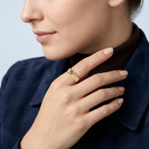 Asymmetrical 18K gold open ring worn on index finger close-up side view sleek bar accent