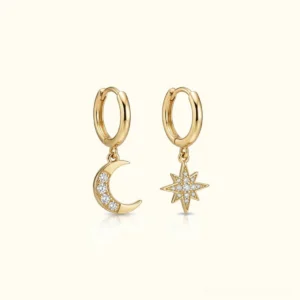 14K gold plated moon and star mismatched hoop drop earrings with crystal pavé charms, asymmetrical celestial design on light beige background