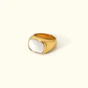 18K gold mother-of-pearl signet ring front view, oval white shell inlay on polished gold band, flat lay product photography with minimalist background