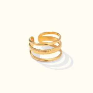 18K gold multi-layer open cuff ring with hammered texture band, top-down flat lay view on light background