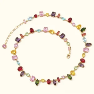 18K gold multicolor gemstone necklace flat lay featuring mixed-cut colorful crystal stones in warm gold-tone chain