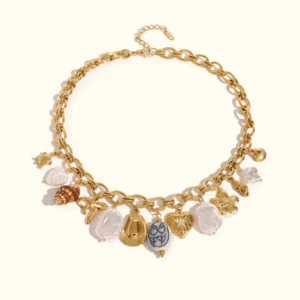 18K gold ocean charm necklace with seashell and pearl pendants displayed in flat lay on neutral background