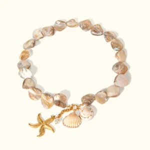18K gold ocean-inspired necklace with iridescent shell beads, starfish charm, pearl pendant, and seashell accent on neutral background