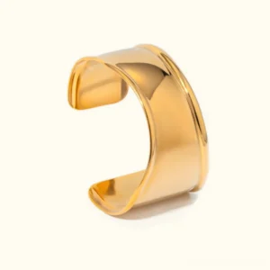 18K gold open cuff bangle with polished finish and raised border detail in studio lighting