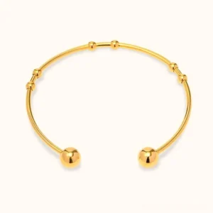 18K gold open cuff bangle with spherical bead details, polished finish, flat lay front view on white background