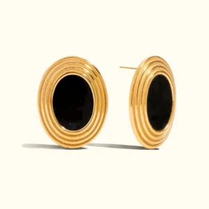 18K gold oval enamel stud earrings with black center stone, front view on plain background, ridged gold frame detail