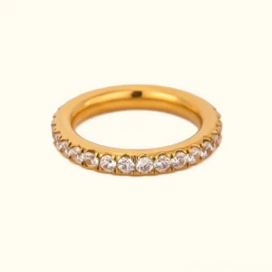 18K gold pavé diamond eternity ring flat lay front view studio shot with off-white background showing full circle of sparkling diamonds in regular and slim band widths