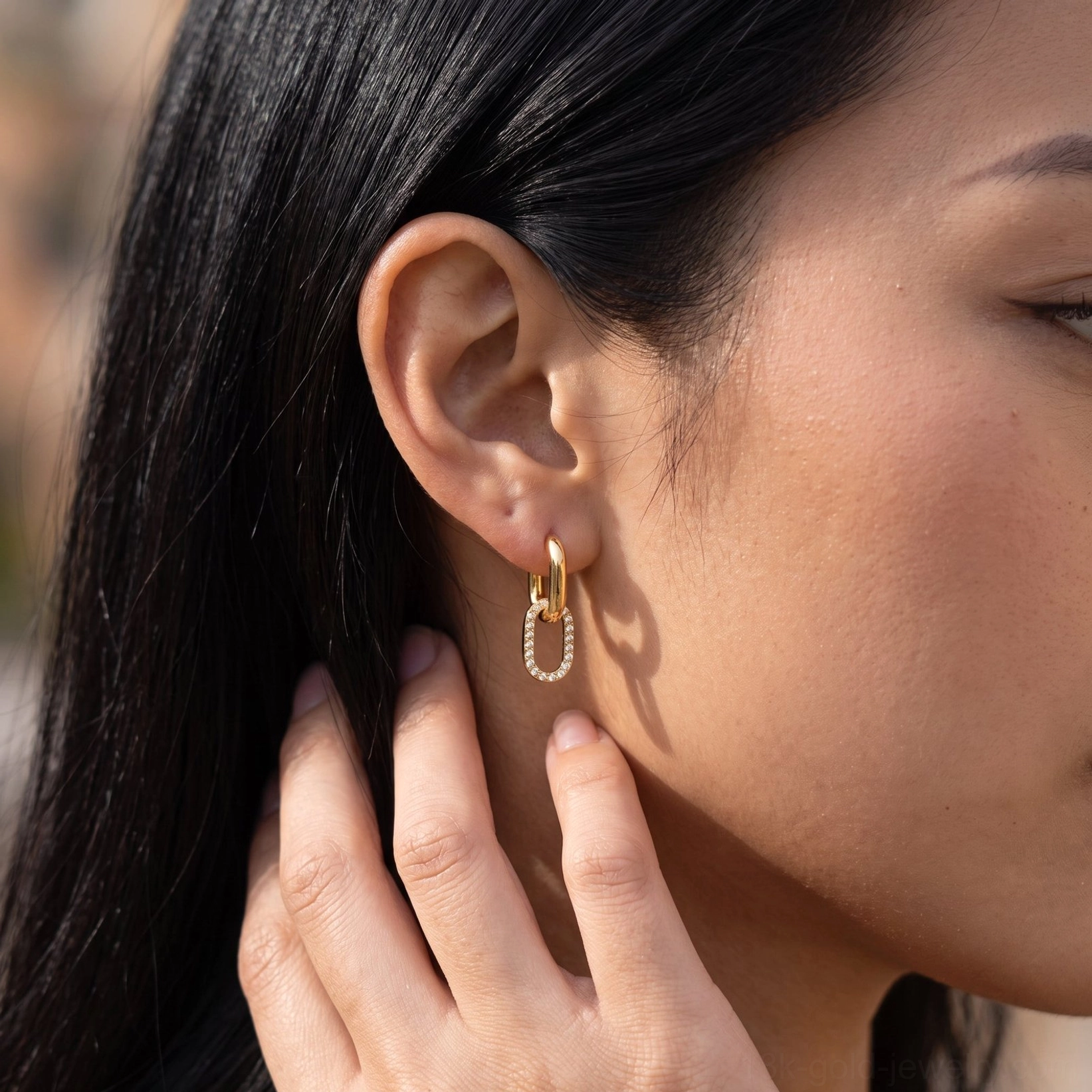 18K gold pavé diamond hoop earrings close-up on Asian model ear, showing crystal-embedded band sparkle