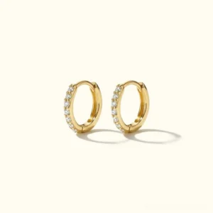 18K gold pavé huggie hoop earrings with diamond simulants, flat lay frontal view showcasing sparkle and detail