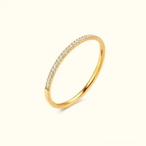 18K gold pavé ring flat lay frontal view showcasing slim band with sparkling cubic zirconia stones and polished finish