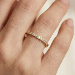 18K gold stackable pavé ring close-up on female hand displaying warm gold tone and brilliant cubic zirconia sparkle