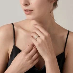 Slim 18K gold pavé ring worn on finger close-up neck hand view single row CZ stones