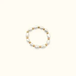 18K gold pearl band ring with freshwater pearls and gold spacer beads, flat lay top-down view on light background