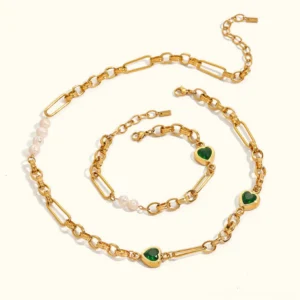 18K gold pearl heart necklace and bracelet bundle flat lay top down view showing mixed gold chains freshwater pearls and green heart charms